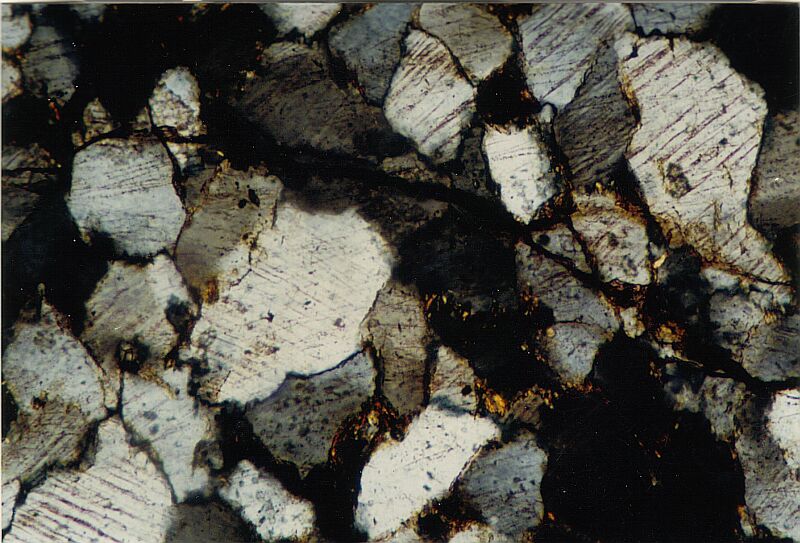 photomicrograph of quartz grains with a high frequency of PDFs, strongly shocked polymictic breccia, Azuara impact structure