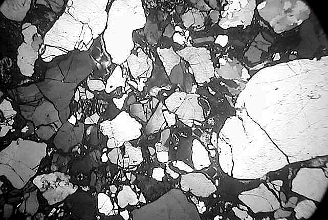 shocked quartz grains with subparallel tensile spallation mirror fractures, sandstone, Rubielos de la Cérida impact basin, Spain