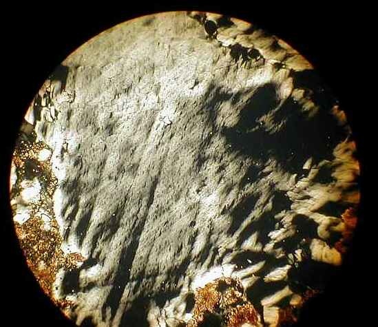 photomicrograph of shocked quartz with planar deformation features and diaplectic glass, Rubielos de la Cérida impact basinsandstone with tensile spallation fractures in quartz, Rubielos de la Cérida impact basin, Spain 